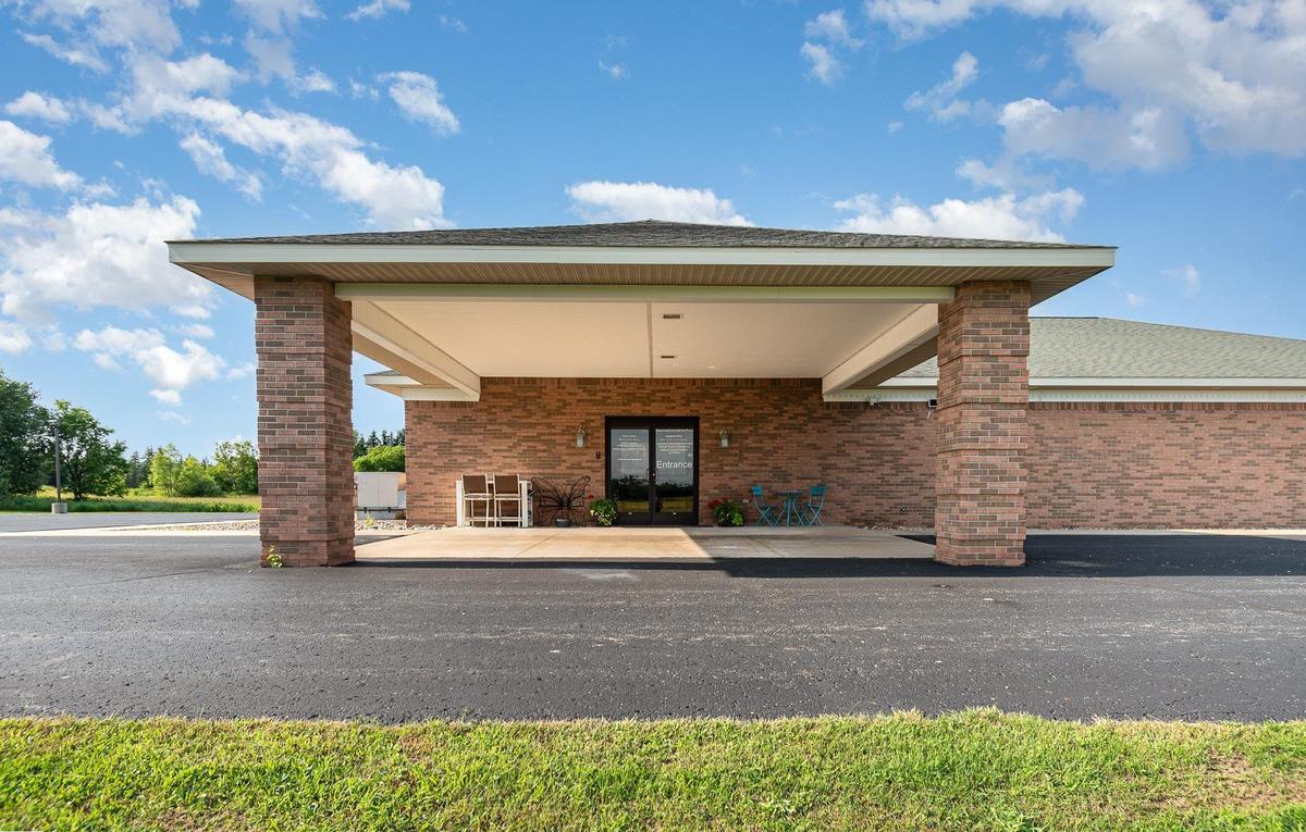 The Blooming Consultants office at 4093 M-65 in Hale, Michigan, a brick building with a covered entrance.